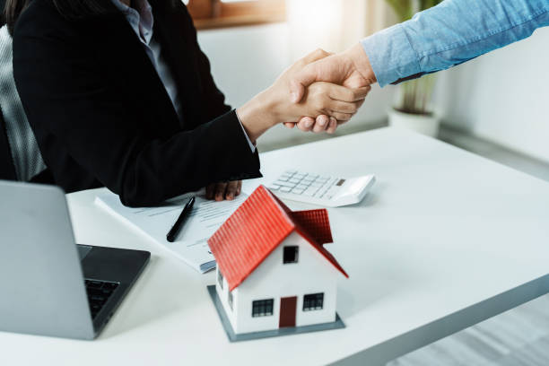 istock Laws, contracts, mortgages, clients join hands with real estate agents congratulating real estate agents on home and land purchase agreements with insurance to reduce risks during home installments 1396670243