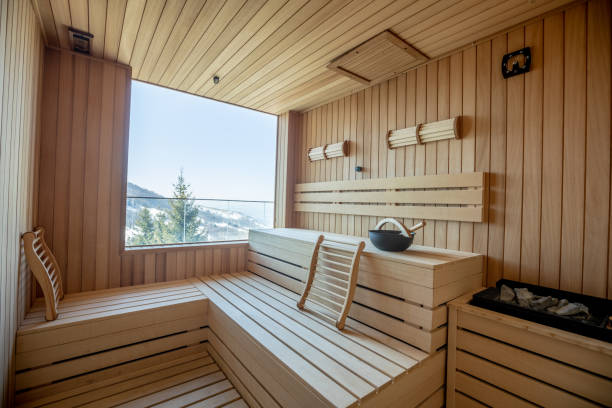 Empty wooden sauna room with traditional sauna accessories stock photo