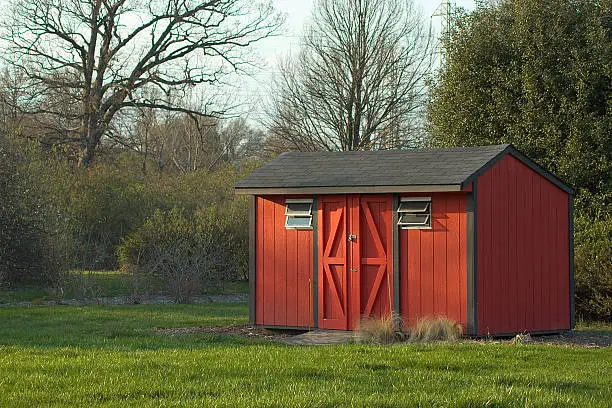 Photo of Rustic backyard shed made of red wood panels