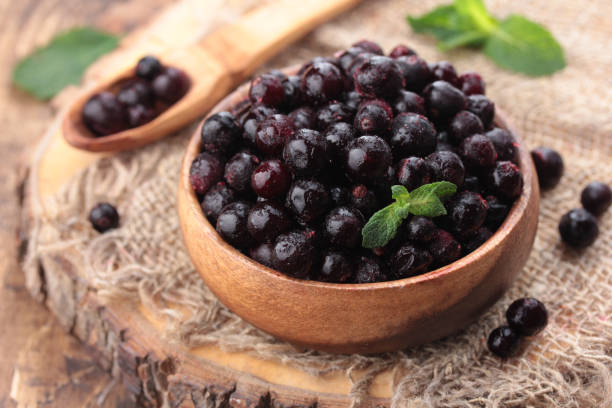 istock Frozen black currants berries in a wooden bowl 1396672786