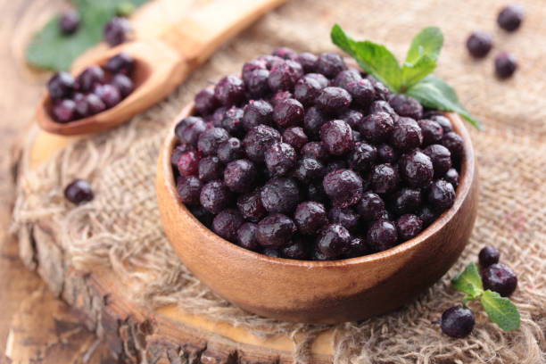 istock Frozen blackberry berries in a wooden bowl 1396672843