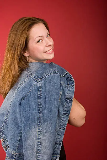 A young woman on her way somewhere, she's got her jacket slung over her shoulder.