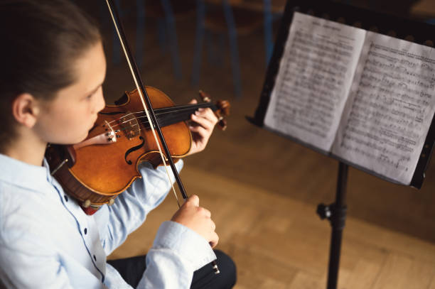 istock Teenage violinist practicing at musical school 1396677462