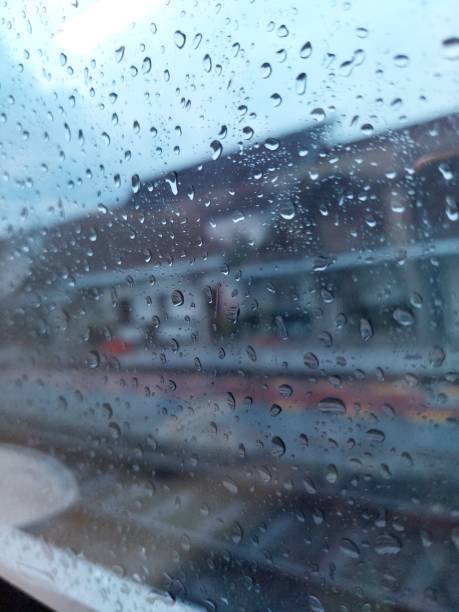 istock rain drops on glass with a beautiful background 1396678951