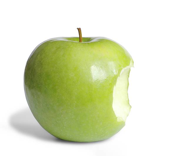 A green apple with a bite taken out of it