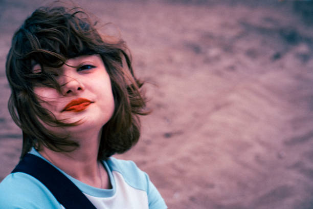 Photo of a young woman quarreling on the beach in a stormy weather