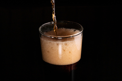 Close-up iced cola isolated in the black background