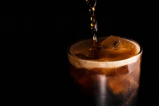 istock Close-up iced cola isolated in the black background 1396680774