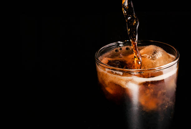 istock Close-up iced cola isolated in the black background 1396680778