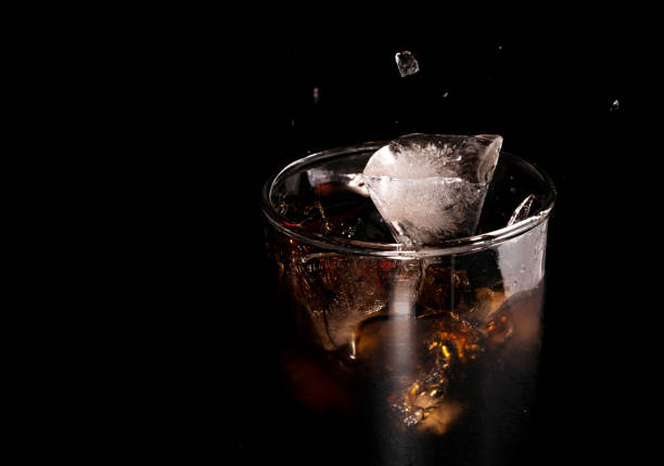 Close-up iced cola isolated in the black background