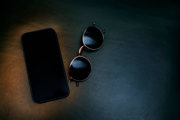Mobile and Sunglass on a Table Lifestyle Image Stock Photo