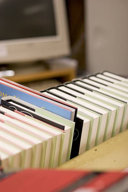 istock Books on a shelf with a computer in background 139668124