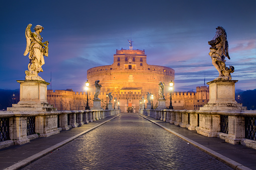 Rome, Italy - February 21, 2022: Castel Sant'Angelo during twilight. It was initially commissioned by the Roman Emperor Hadrian and construction began in 123 AD.
