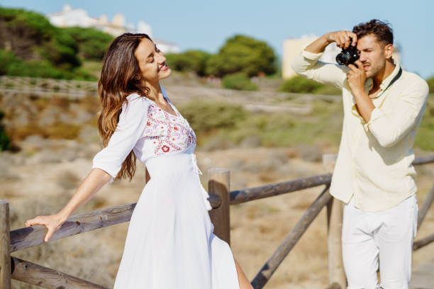 istock Man photographing his girlfriend on a lovers' trip. 1396682373