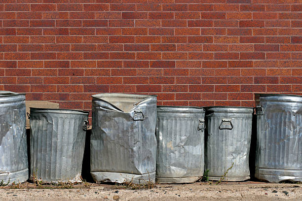 istock Banged up metal trash cans in an urban setting 139668377