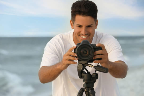 istock Photographer working with professional camera near sea 1396686390