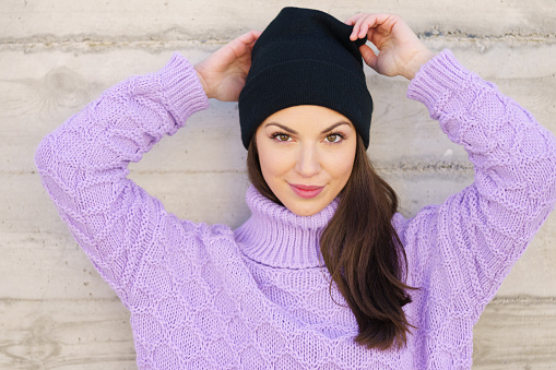 Happy young woman wearing winter hat. Lifestyle concept.