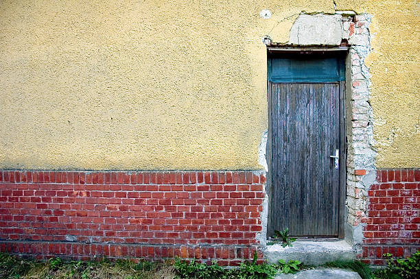 door in brick and plaster wall stock photo