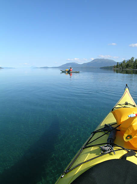 A tour of beautiful blue waters on a sea kayak stock photo