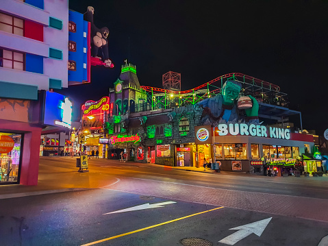 Niagara Falls, Ontario, Canada - September 24, 2020:  On Clifton Hill Street at Niagara Falls, you can see Ripley's Moving Theatre 4D, Frankenstein, Burger King,  Burger Factory, Beavertails, Candy Shop, The Chrystal Caves and Ripley's Believe It or Not. You can see people walking on the street.
