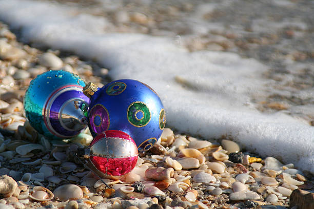 Tropical Christmas Christmas bulbs at the seashore with surf florida christmas stock pictures, royalty-free photos & images