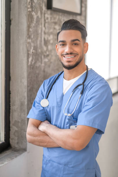 istock Joyous physician posing for the camera in his office 1396691167