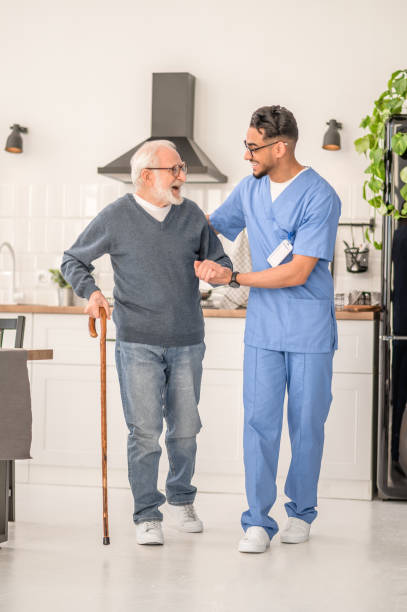 istock Patient moving around the kitchen assisted by his in-home nurse 1396691304