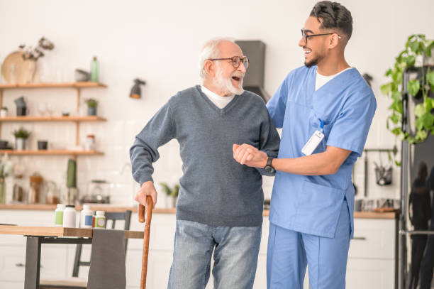 istock Patient leaning on the cane supported by a young nurse 1396691306