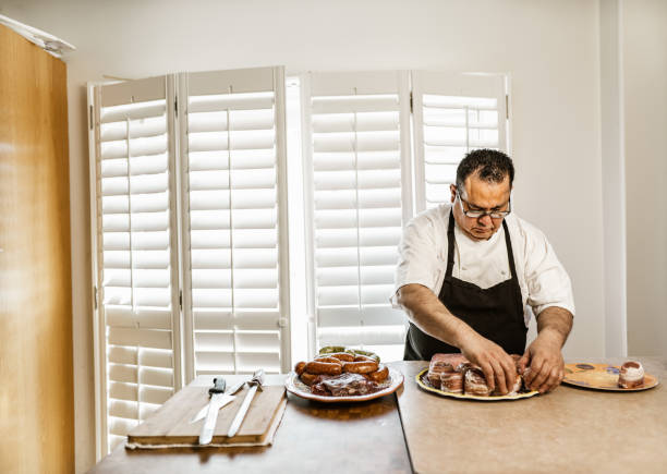 istock Mature Latin Chef preparing meat variety ready for BBQ 1396692368