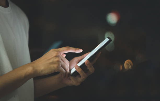 istock Person holding mobile phone, touching white screen. 1396692682
