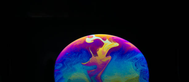 istock Half a soap bubble. Close-up. Black background. Bright colors. Side view. Imitation of an unknown planet. Science fiction 1396694674
