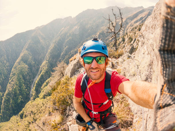 istock Man taking selfie on a Via Ferrata route 1396694778