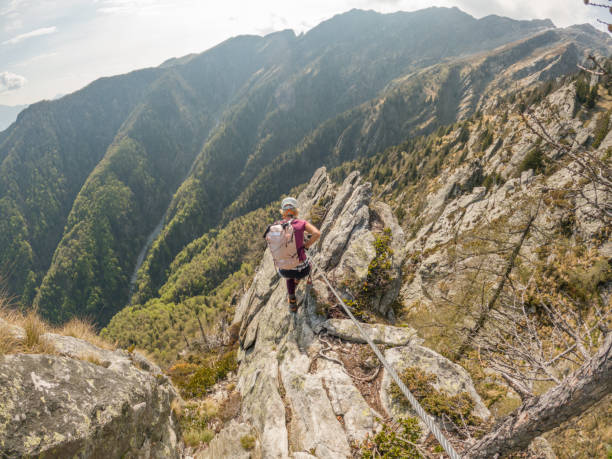 istock Woman rock climbing on Via Ferrata route 1396694811