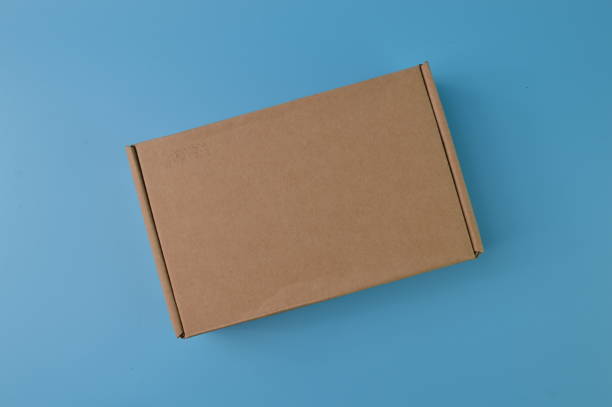 istock Brown paper box isolated on a blue background 1396694859