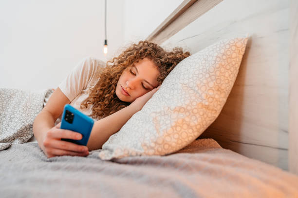 istock Young Woman Using Phone In The Morning In Bed 1396696362