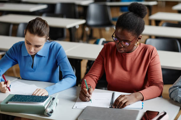 istock Students Taking Exam in School Closeup 1396696380