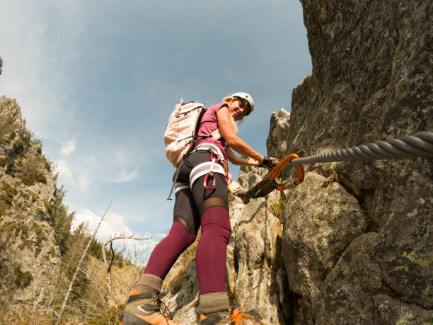 istock Woman rock climbing on Via Ferrata route 1396696677