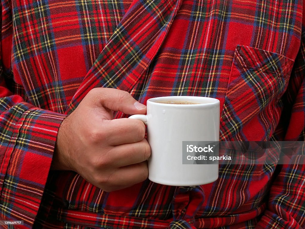 Saturday morning man drinking coffee in his bathrobe Bathrobe Stock Photo