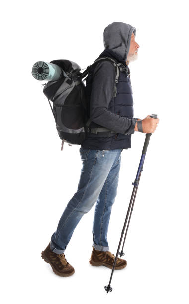 istock Male hiker with backpack and trekking poles on white background 1396697804