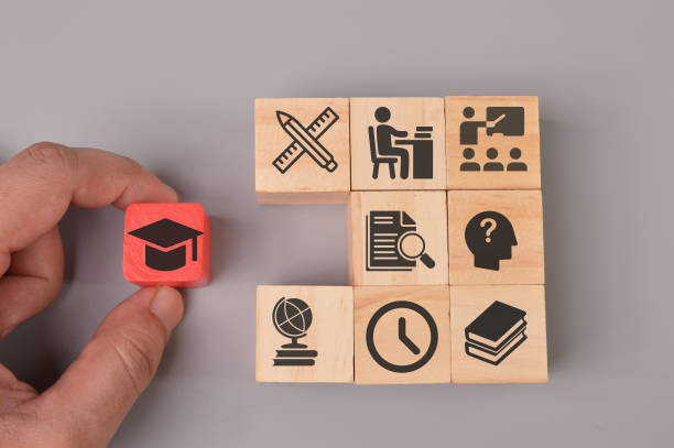 istock Hand holding graduation cap with learning icons. Success concept 1396697838