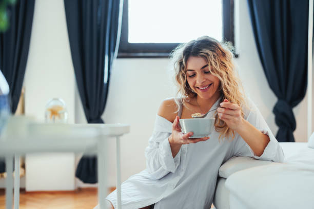 istock Smiling woman has breakfast at home 1396697841