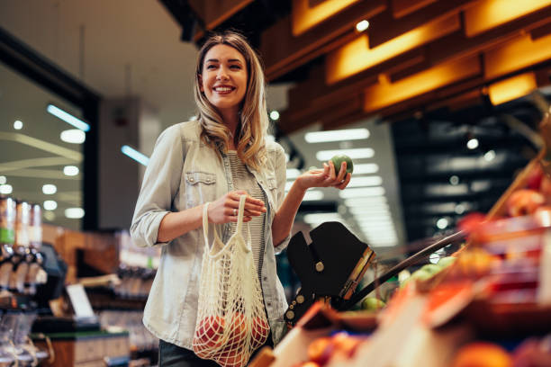 Young woman buying groceries at the supermarket stock photo