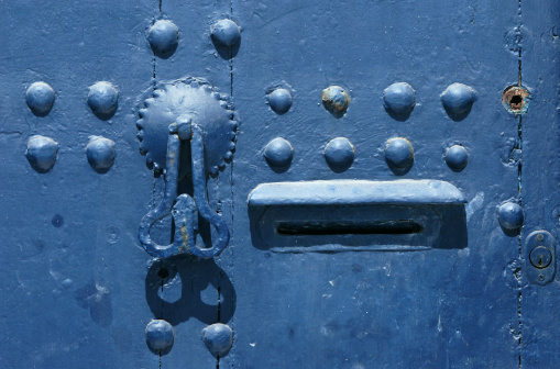 A blue knocker on a blue door of a traditional Moroccan house in the Oudaia Kasbah in Rabat, Morocco. The Oudaua Kasbah is the oldest part of the modern Moroccan capital.