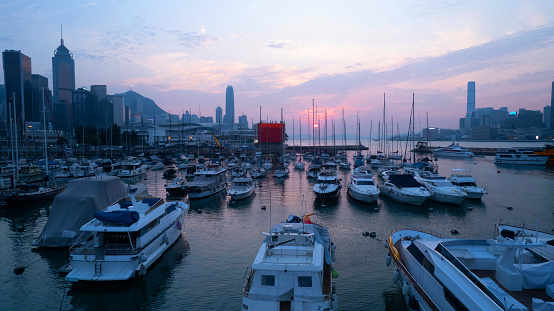 Victoria Harbour and yachts parking in typhoon shelter during sunset