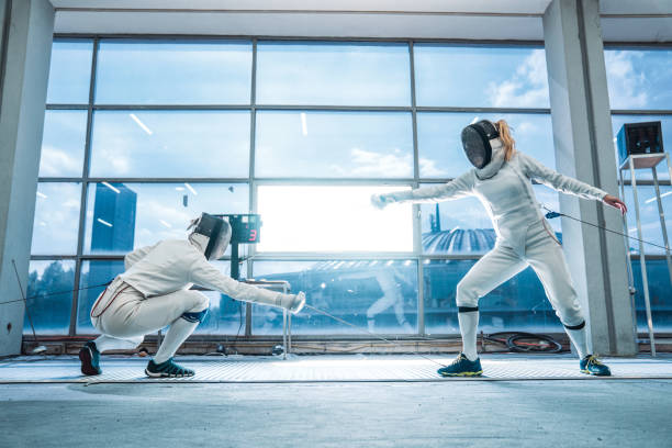 Scene of fencing duel of two professional sports women