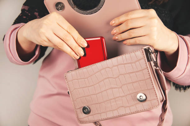 istock woman hand phone in bag 1396703930