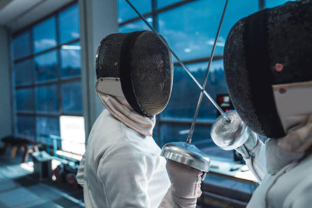istock Face to face -two professional female fencers at training 1396705549