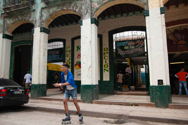Young man riding his skates across a street in Old Havana, Cuba stock photo