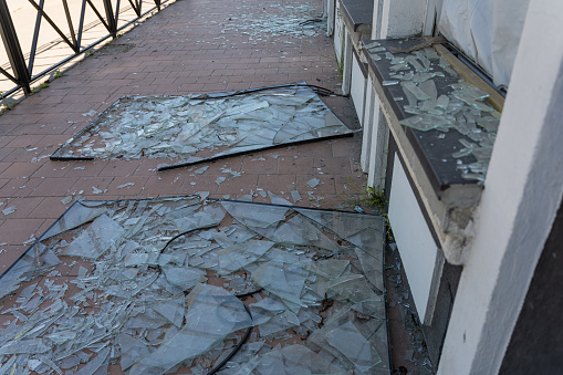 La fachada de un edificio con concha. Las ventanas rotas se encuentran a lo largo de la pared. Las secuelas del bombardeo de una ciudad ucraniana. La invasión rusa de Ucrania en 2022. No hay gente. photo