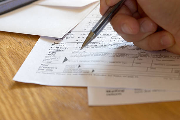 Signing the Tax form stock photo